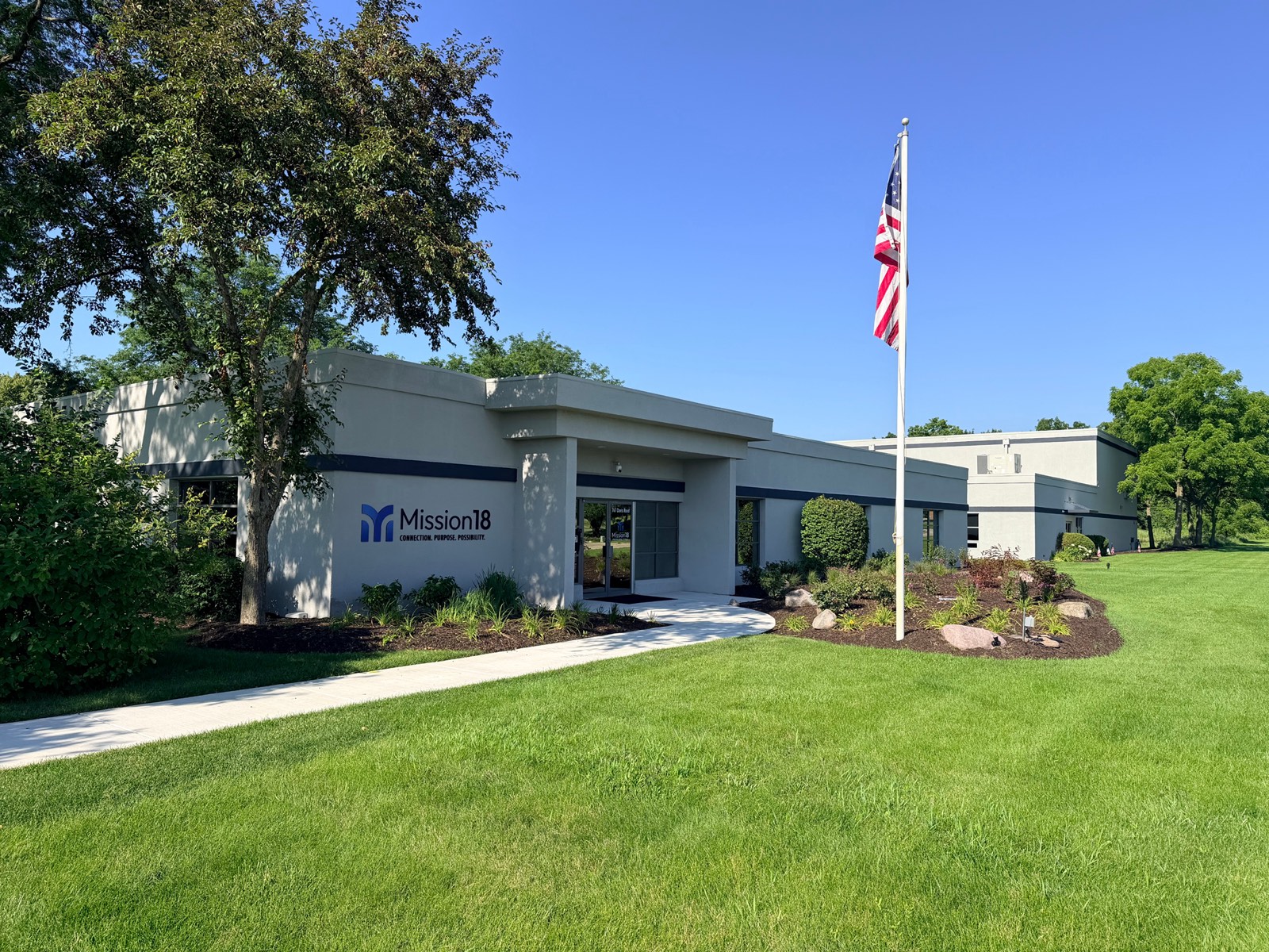 A commercial office building in McHenry County with a professionally maintained lawn and flagpole