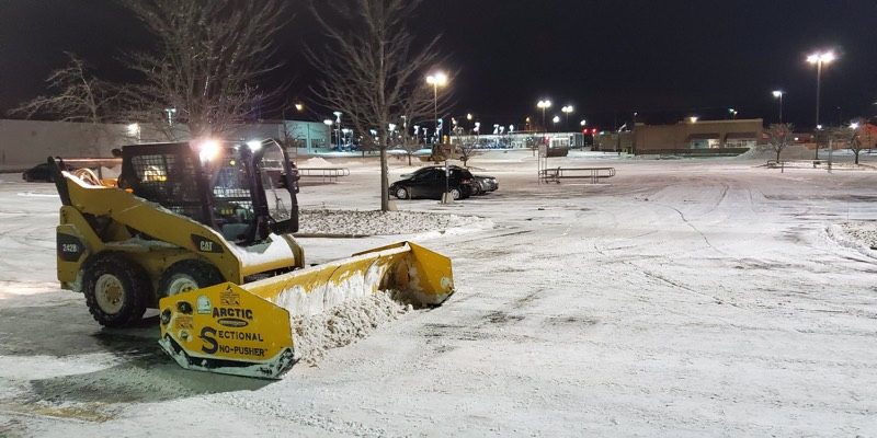 Snow removal equipment clearing a commercial lot in Cary