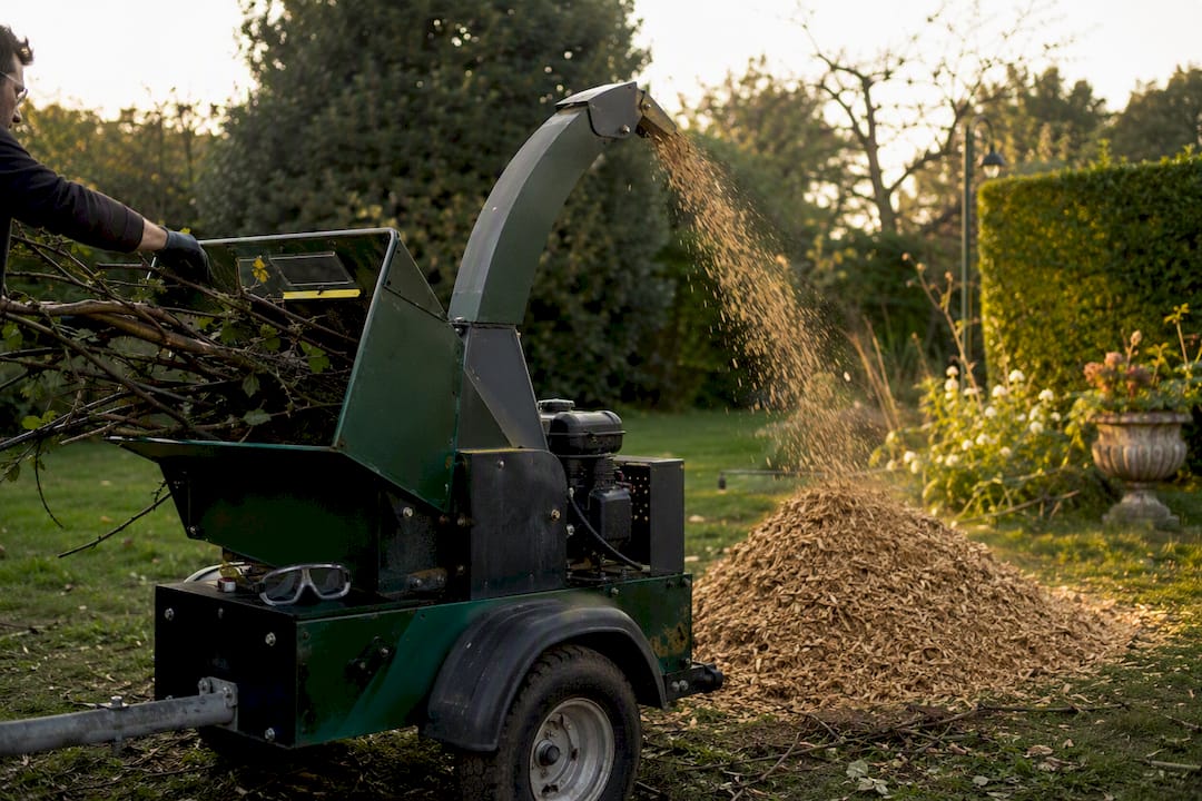 Wood chipper mulching branches outdoors