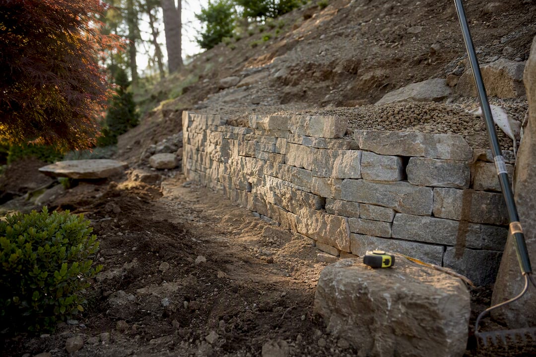 Retaining wall with drainage backfill on slope