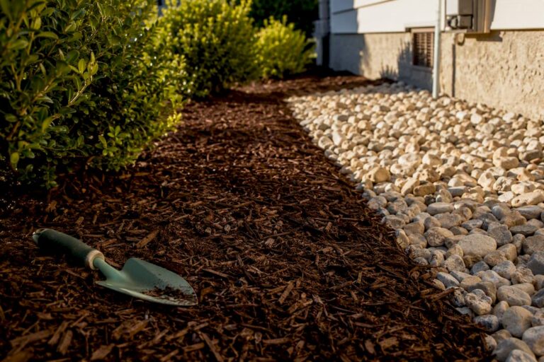 Mulch and rock beside residential planting bed